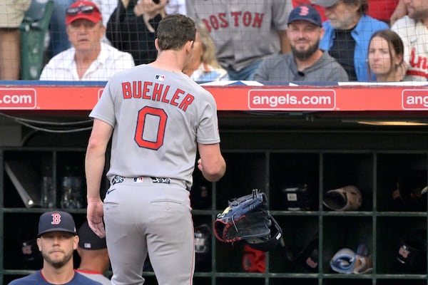 Boston Red Sox starting pitcher Walker Buehler (0) tosses his glove and cap into the dugout as he leaves the field after giving up five runs during the first inning of a baseball game against the Los Angeles Angels, Monday, June 23, 2025, in Anaheim, Calif. (AP Photo/Jayne Kamin-Oncea)