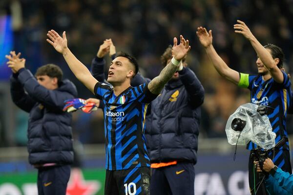 Inter Milan players celebrate at the end of the Champions League quarterfinal second leg soccer match between Inter Milan and Bayern Munich at the San Siro stadium in Milan, Italy, Wednesday, April 16, 2025. (AP Photo/Luca Bruno)