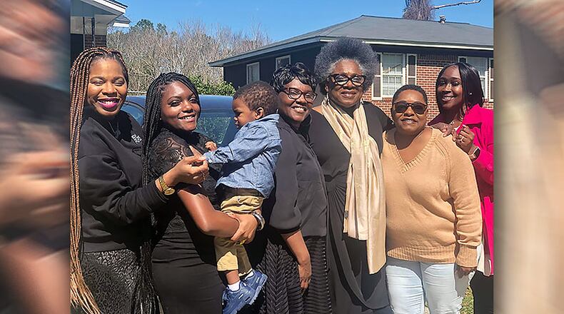 After the funeral of 64-year-old Andrew J. Mitchell on Feb. 29, his relatives attended a repast, then gathered again at one of his sisters homes. Dozens of family members later fell ill. Pictured outside the sisters home on that day are, left to right, Abrigail Johnson, Margaret Mansfield, Brenden Mansfield (baby), Jacqueline Mansfield, Dorothy Johnson, Tonya Thomas and Nakimbra Savage. Thomas is now in critical condition at Piedmont Fayette Hospital. SPECIAL