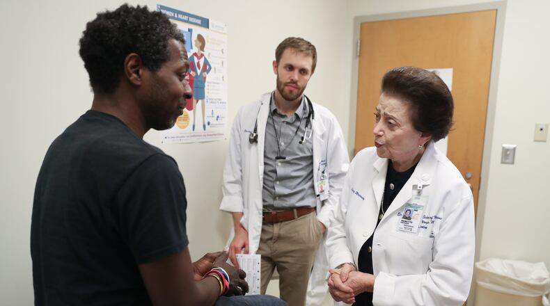 Dr. Nanette Wenger, a cardiologist, right, talks with patient Renard Quinn at Grady Hospital. Also pictured is Resident Physician Brad Witbrodt, center. (PHOTO COURTESY OF JASON GETZ)