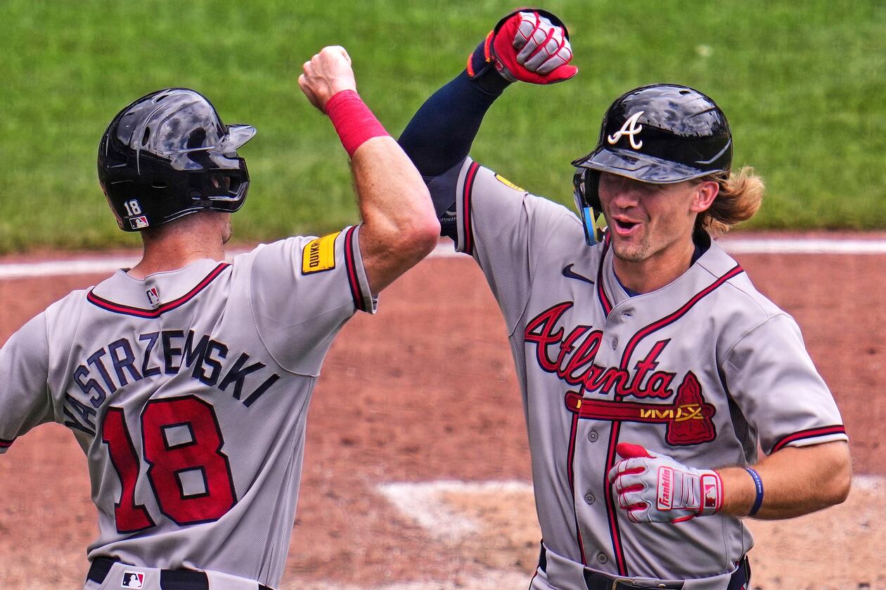 Atlanta Braves' Jim Jarvis, right, celebrates with Mike Yastrzemski (18) as he returns to the dugout after hitting a two-run home run off Pittsburgh Pirates pitcher Cam Sanders during the fourth inning of a baseball game in Pittsburgh, Thursday, July 9, 2026. (AP Photo/Gene J. Puskar)