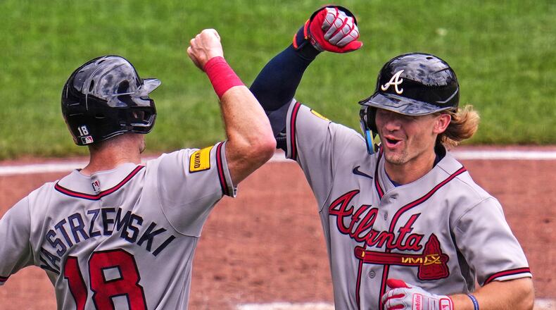 Atlanta Braves' Jim Jarvis, right, celebrates with Mike Yastrzemski (18) as he returns to the dugout after hitting a two-run home run off Pittsburgh Pirates pitcher Cam Sanders during the fourth inning of a baseball game in Pittsburgh, Thursday, July 9, 2026. (AP Photo/Gene J. Puskar)