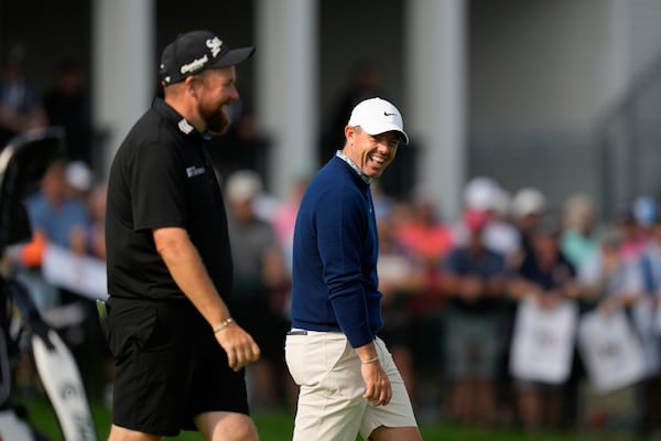 Rory McIlroy, of Northern Ireland, right, laughs with Shane Lowry, of Ireland, as they walk on the 18th green during a practice round ahead of the U.S. Open golf tournament at Oakmont Country Club Tuesday, June 10, 2025, in Oakmont, Pa. (AP Photo/Seth Wenig)
