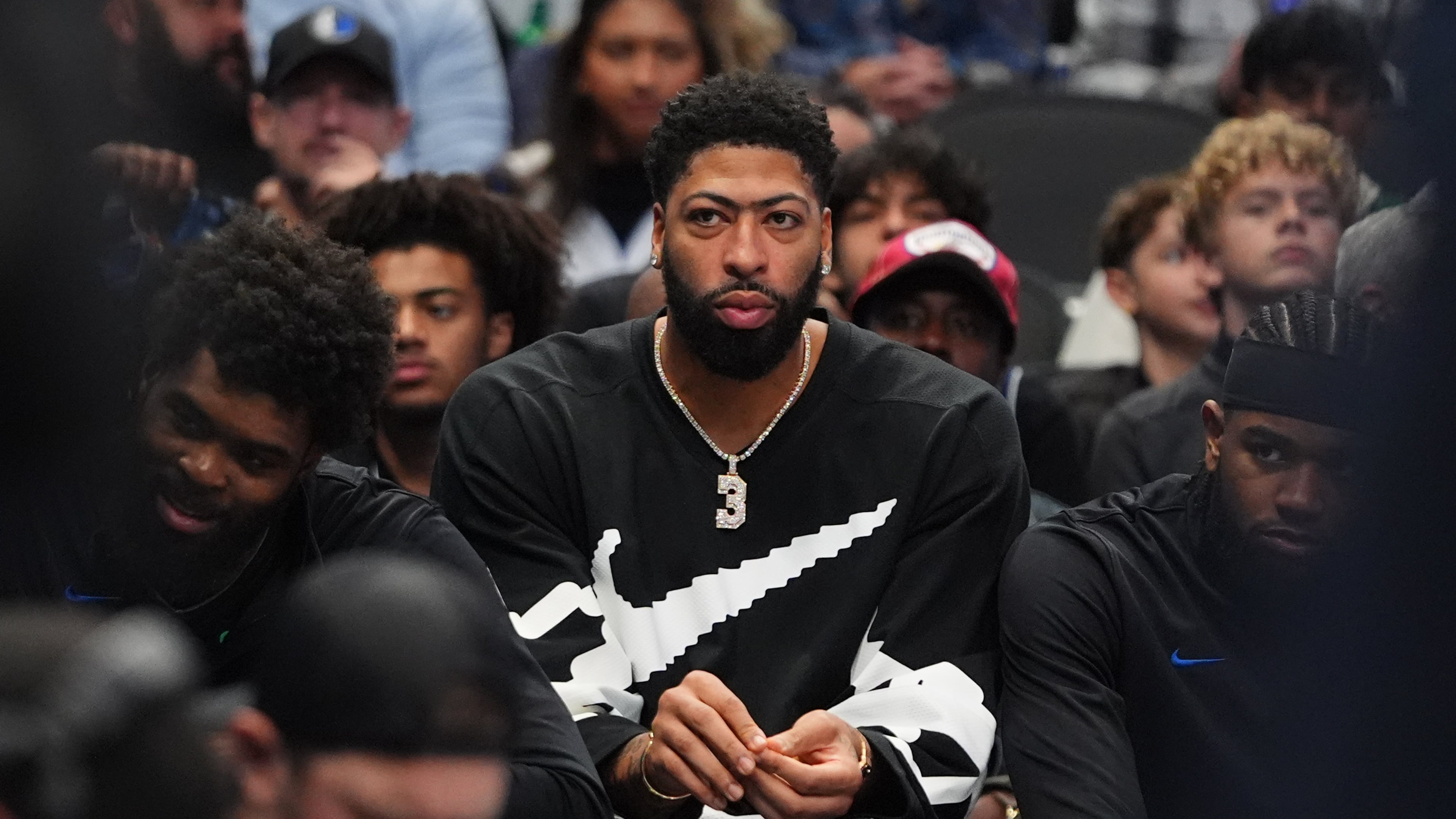 Injured Dallas Mavericks forward Anthony Davis, center, sits on the bench during the second half of an NBA basketball game against the Memphis Grizzlies in Dallas, Saturday, Nov. 22, 2025. (AP Photo/LM Otero)