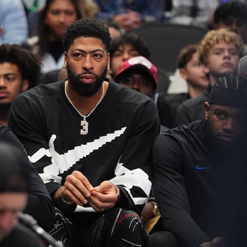 Injured Dallas Mavericks forward Anthony Davis, center, sits on the bench during the second half of an NBA basketball game against the Memphis Grizzlies in Dallas, Saturday, Nov. 22, 2025. (AP Photo/LM Otero)