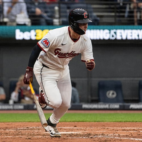 Cleveland Guardians' Cooper Ingle watches his first Major League hit, a two-run single off Seattle Mariners starting pitcher Logan Gilbert as Cal Raleigh moves into position during the third inning of a baseball game, Saturday, June 27, 2026, in Cleveland. (AP Photo/Phil Long) CORRECTION: Corrects to a two-run single not an RBI single