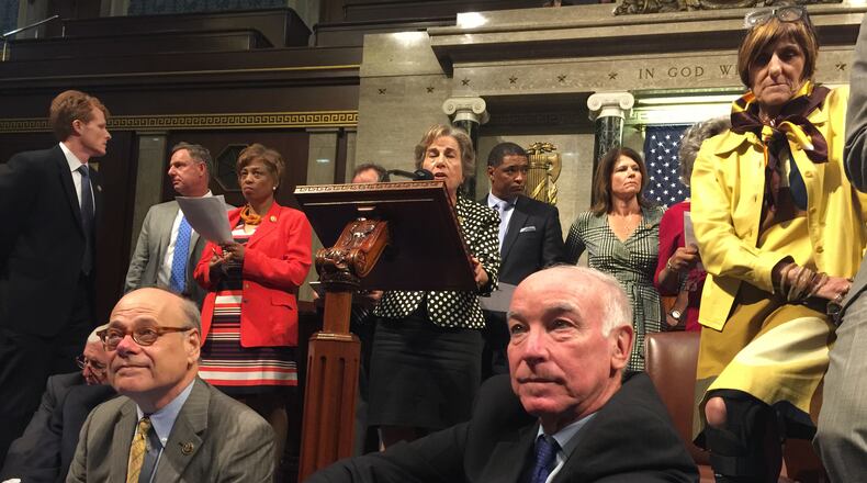 This photo provided by Rep. Chellie Pingree, D-Maine shows Democrat members of Congress, including, front row, from left, Rep. Steve Cohen, D-Tenn., Rep. Joe Courtney, D-Conn., and Rep. Rosa DeLauro, D-Conn., participate in sit-down protest seeking a a vote on gun control measures, Wednesday, June 22, 2016, on the floor of the House on Capitol Hill in Washington. (Rep. Chellie Pingree via AP)