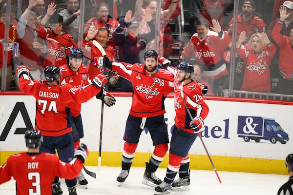 Washington Capitals right wing Tom Wilson, second from right, celebrates his goal in the third period of Game 2 of a second-round NHL hockey playoff series against the Carolina Hurricanes, Thursday, May 8, 2025, in Washington. (AP Photo/Nick Wass)