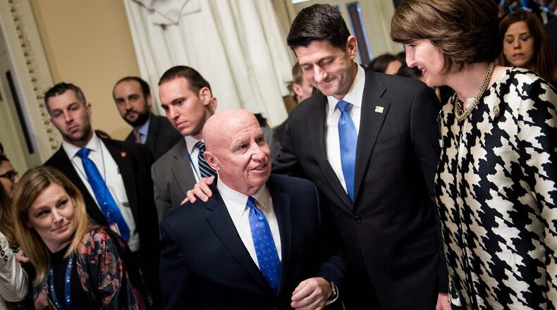 Speaker of the House Paul Ryan, center, R-W.I., pats House Ways and Means Committee Chairman Rep. Kevin Brady, left, R-Texas, on the back after the House passed tax reform legislation, Tuesday. Cathy McMorris Rodgers, R-Wash., right, looks on. Celebration will have to wait, however. The bill hit a late-afternoon glitch in the Senate when the parliamentarian ruled that three minor provisions in the GOP bill did not comply with strict budget rules and would have to be stripped out.