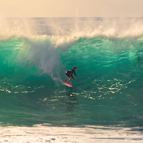 This photo provided by Steve Hague shows a surfer at Newport Beac, Saturday, Sept. 5, 2026, in Newport Beach, Calif. (Steve Hague via AP)