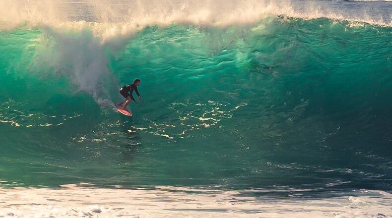This photo provided by Steve Hague shows a surfer at Newport Beac, Saturday, Sept. 5, 2026, in Newport Beach, Calif. (Steve Hague via AP)