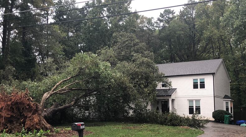 A large tree fell on a house on Womack Road in Dunwoody early Thursday, Oct. 29, 2020, as the remnants of Hurricane Zeta swept through Georgia. (Photo by J. Scott Trubey/strubey@ajc.com)