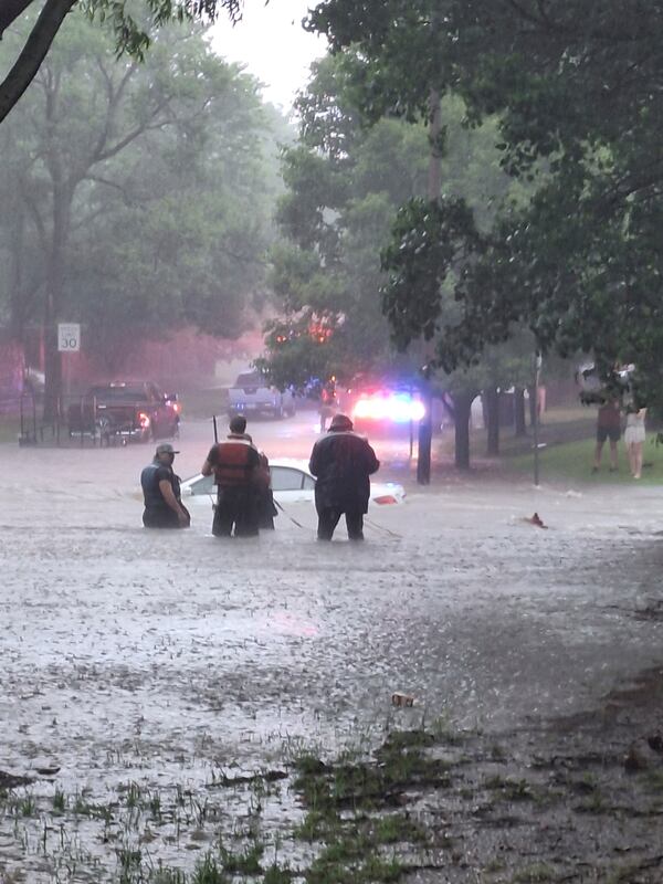 This photo provided by Colin Fee, a vehicle is surrounded by flood waters as heavy rains caused flash flooding in the Wichita area of south-central Kansas forcing firefighters to rescue dozens of people, including stranded motorists on Tuesday, June 3, 2025. (Colin Fee via AP)