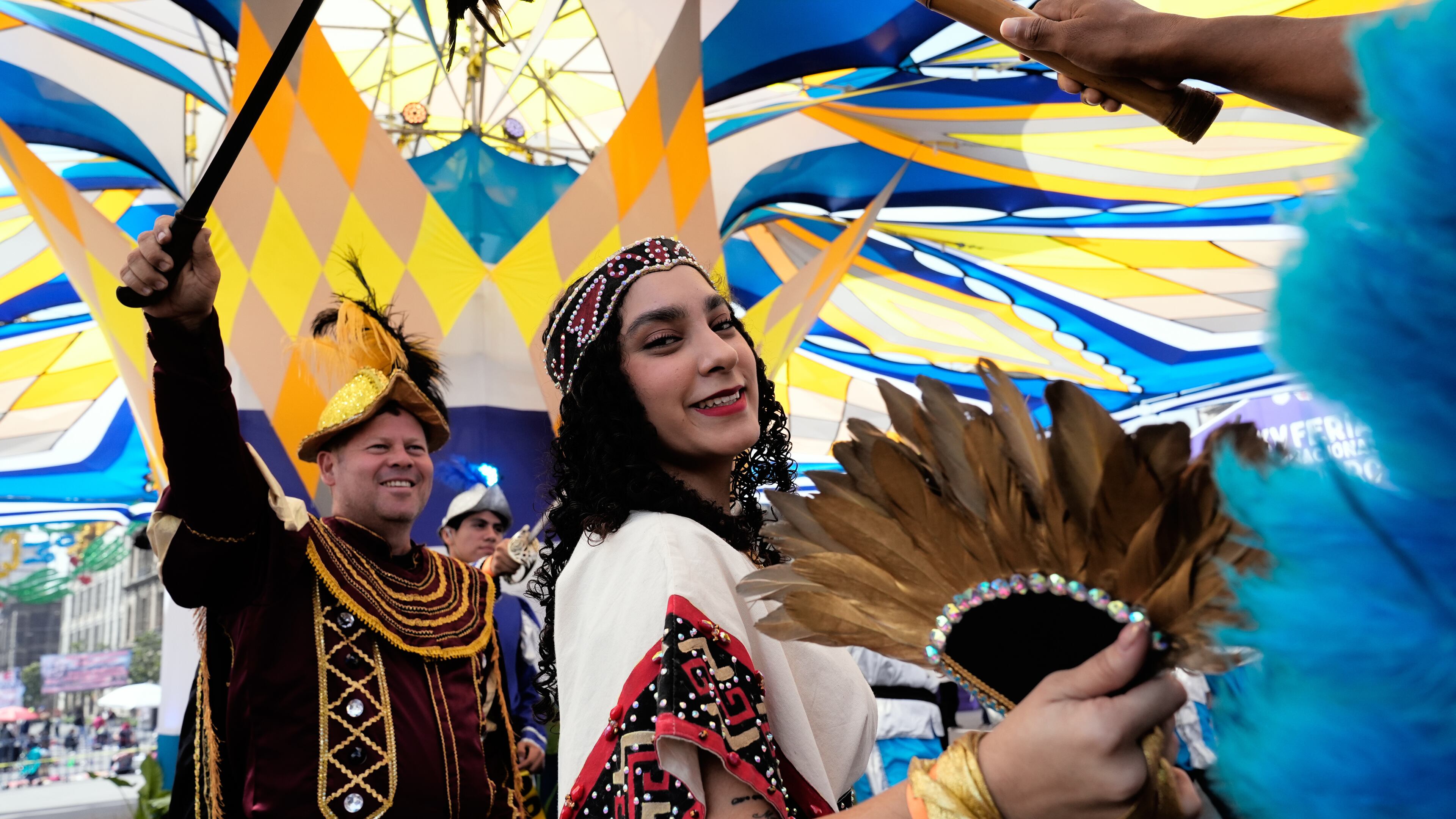 La Malinche, represented by Ximena Isabel Ochoa López, and Hernán Cortez, represented by José Antonio Ochoa Lopez, left, take part in a pre-Hispanic dance in the Zocalo, in Mexico City, Sunday, Oct. 12, 2025. (AP Photo/Marco Ugarte)