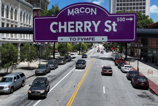 A street sign features both English and Muscogee (Creek) language translations in downtown Macon, part of a growing effort to recognize the area's original inhabitants. (Hyosub Shin/AJC)