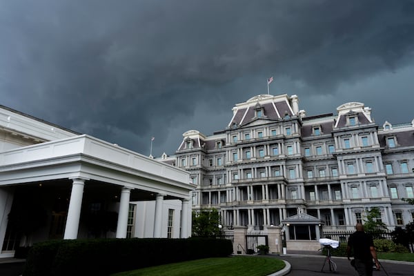 The dark clouds of an approaching thunderstorm move over the Old Eisenhower Executive Office Building and the West Wing of the White House, Thursday, June 19, 2025, in Washington. (AP Photo/Alex Brandon)