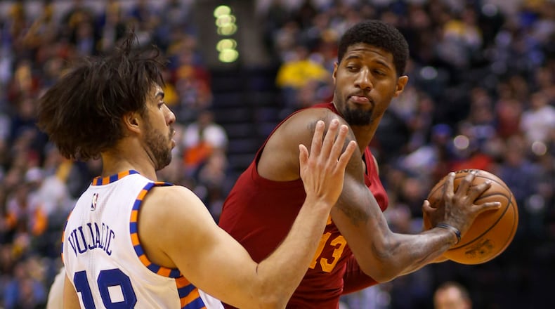 Indiana Pacers forward Paul George (13) looks to pass around New York Knicks guard Sasha Vujacic (18) during the second half of an NBA basketball game in Indianapolis, Wednesday, Feb. 24, 2016. The Pacers won 108-105. (AP Photo/AJ Mast)