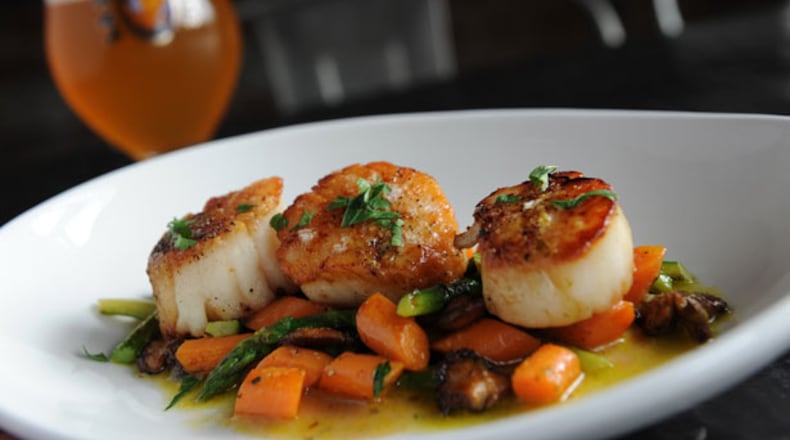 Pan roasted scallops with asparagus, baby carrots, hedgehog mushrooms and meyer lemon vin at Argosy in East Atlanta.