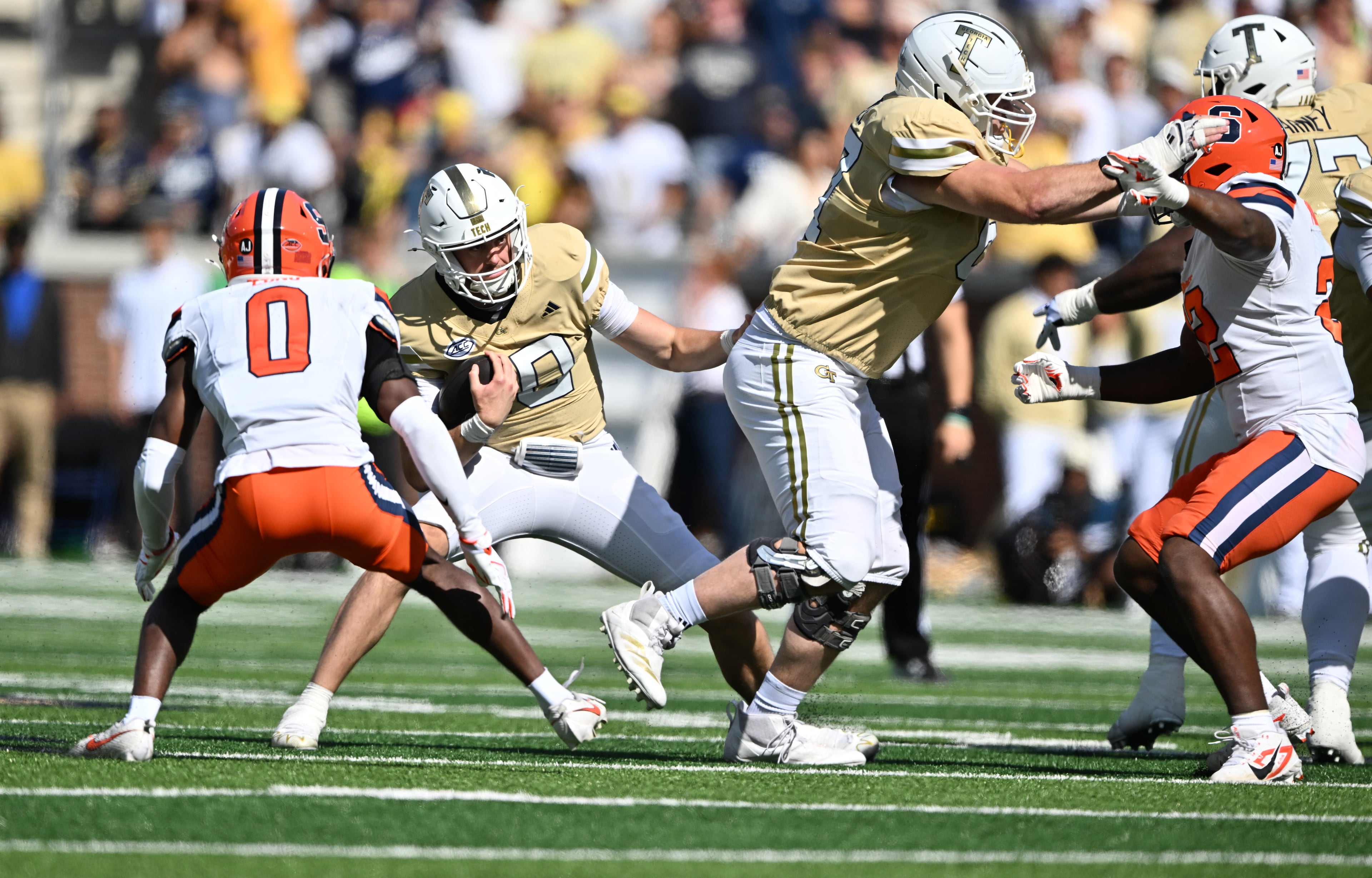 Georgia Tech quarterback Haynes King (10) runs the ball against Syracuse defensive back Braheem Long Jr. (0) during the first half of an NCAA college football game at Bobby Dodd Stadium, Saturday, October 25, 2025 in Atlanta. (Hyosub Shin / AJC)