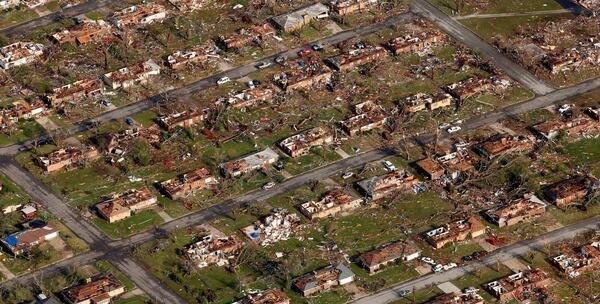 FILE- This aerial photograph shows a neighborhood destroyed by a powerful tornado in Joplin, Mo. Tuesday, May 24, 2011. (AP Photo/Charlie Riedel, File)