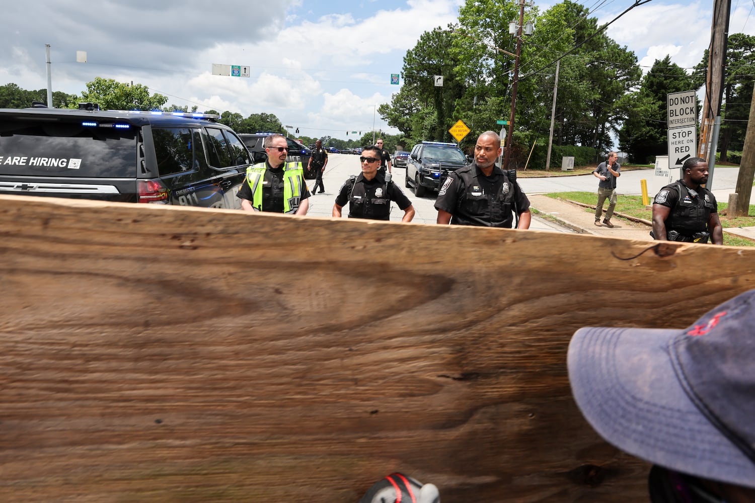 Demonstrators hold a wood barricade during a protest on ICE raids and deportation arrests on Chamblee Tucker Road in Atlanta on Saturday, June 14, 2025. (Arvin Temkar / AJC)