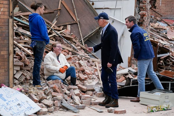 FILE - President Joe Biden, center right, and Kentucky Gov. Andy Beshear, right, talk to people as they survey storm damage from tornadoes and extreme weather in Mayfield, Ky., Dec. 15, 2021. (AP Photo/Andrew Harnik, File)