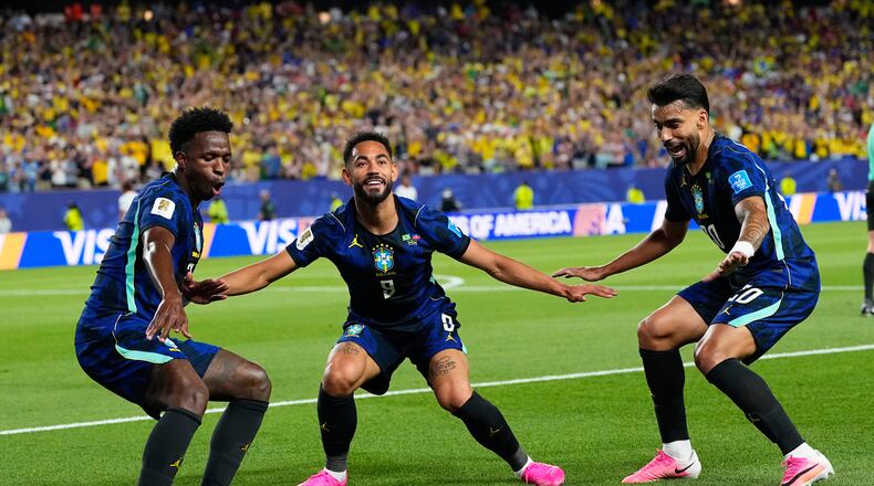 Brazil's Matheus Cunha (9) celebrates after scoring his side's second goal with Brazil's Vinicius Junior (7) and Lucas Paqueta (20) during the World Cup Group C soccer match between Brazil and Haiti in Philadelphia, Friday, June 19, 2026. (AP Photo/Petr David Josek)