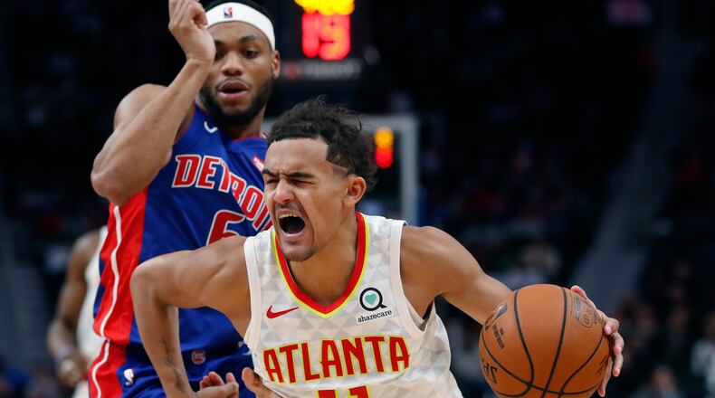 Hawks guard Trae Young (11) drives on Detroit Pistons guard Bruce Brown during the second half of an NBA basketball game Friday, Nov. 22, 2019, in Detroit. (AP Photo/Carlos Osorio)