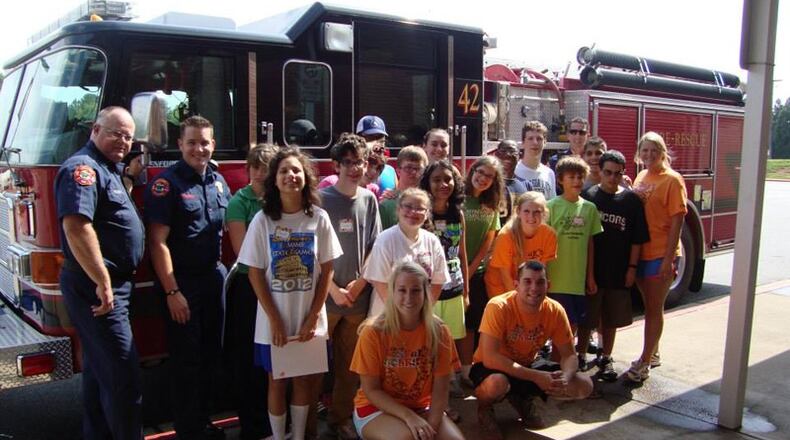 Participants of a past Camp Joyful Soles visit with firefighters. Milton has renewed an agreement with the Fulton County Schools to continue using Hopewell Middle School as the site of Camp Joyful Soles. CAMP JOYFUL SOLES via Facebook