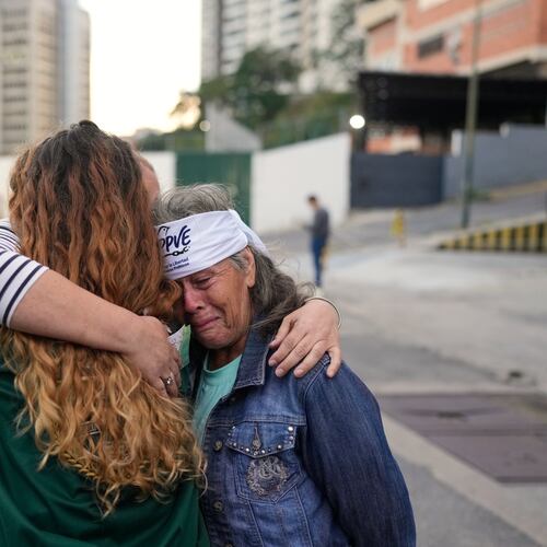 Flor Zambrano, whose son, Rene Chourio, she says is detained at Zone 7 of the Bolivarian National Police for political reasons, embraces relatives of other detainees outside the facility in Caracas, Venezuela, Monday, Jan. 12, 2026. (AP Photo/Matias Delacroix)