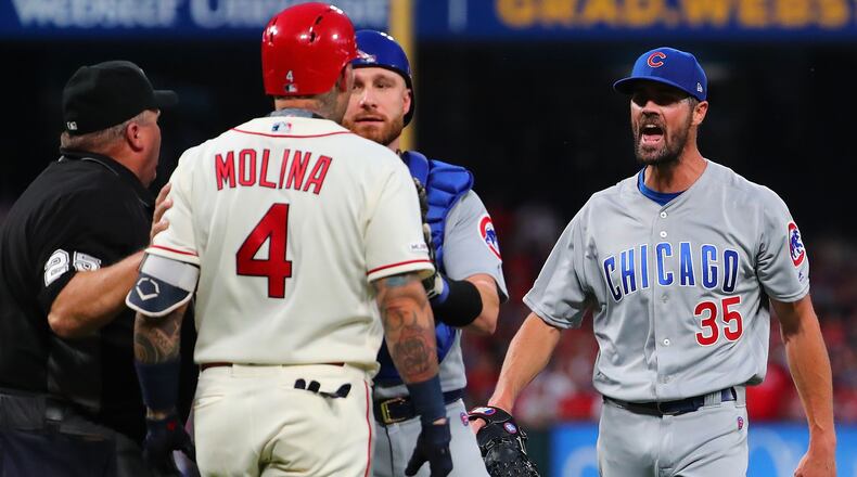 Jonathan Lucroy  of the Chicago Cubs restrains Yadier Molina  of the St. Louis Cardinals as he confronts Cole Hamels of the Chicago Cubs after he hit Molina with a pitch in the second inning at Busch Stadium on September 28, 2019 in St Louis, Missouri. (Photo by Dilip Vishwanat/Getty Images)