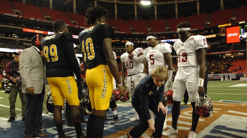 MEAC champs North Carolina Central goes up against SWAC champs Grambling State in the Air Force Reserve Celebration Bowl at the Georgia Dome in Atlanta. Lt. General Mary Ann Miller retrieves the coin that has just been flipped signaling the start of the game. (W.A. Bridges Jr./Special to the AJC)