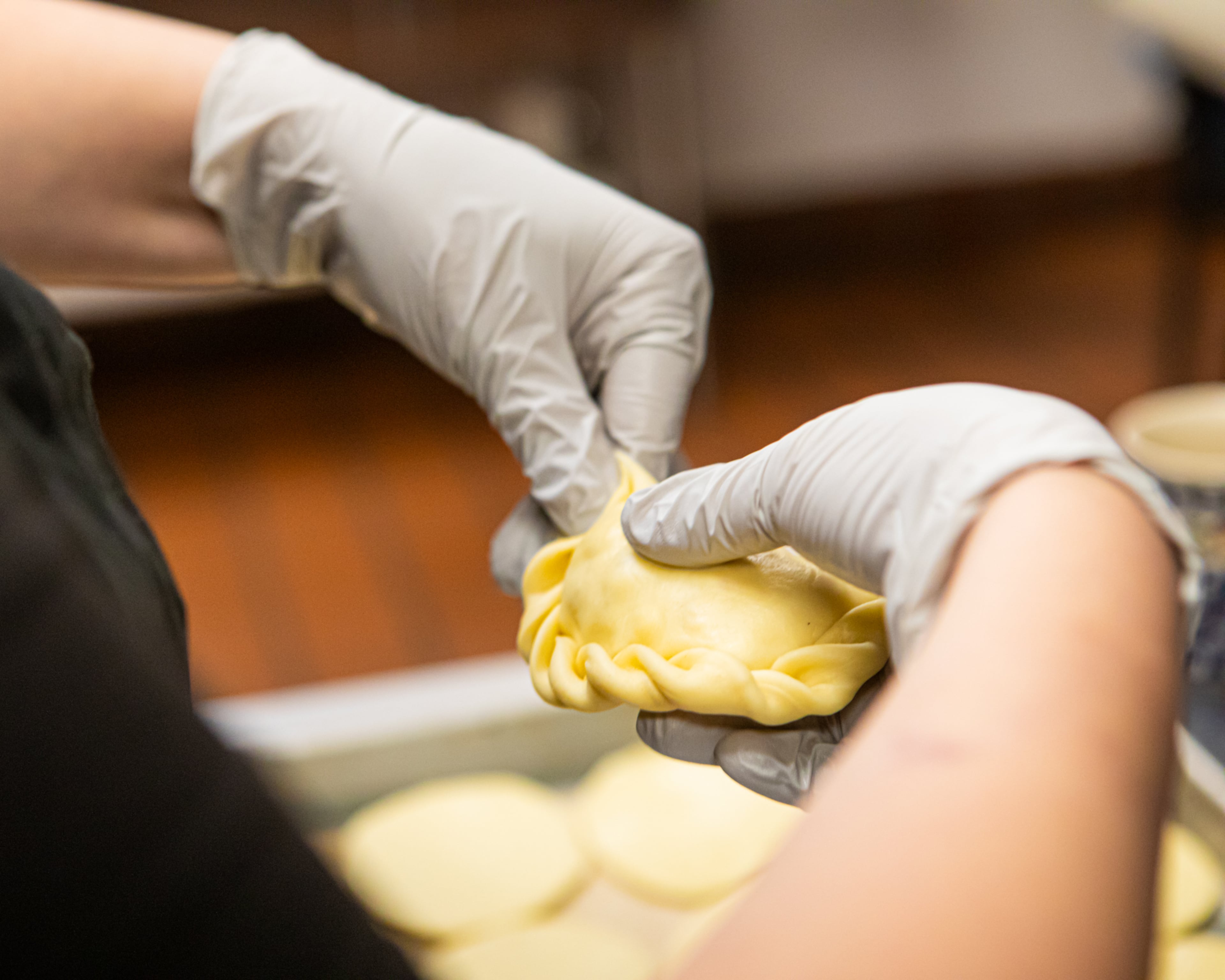 Every pierogi-maker has a preferred way of sealing their dumplings. Basia Piechoczek likes to braid the edges, a method she learned at a pierogi shop in Poland. (Aaliyah Man for the AJC)