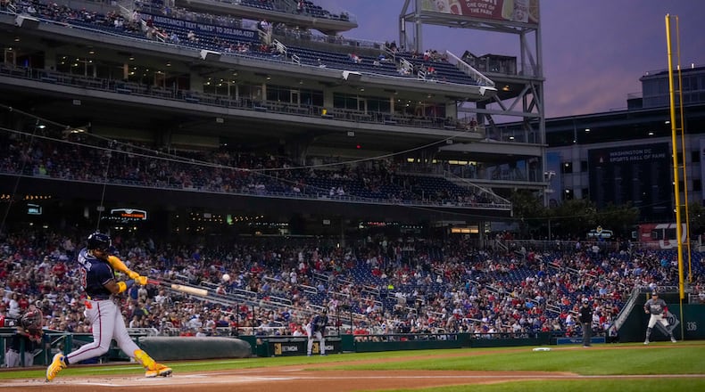 Atlanta Braves' Ronald Acuna Jr. hits a solo home run during the first inning of a baseball game against the Washington Nationals at Nationals Park, Friday, Sept. 22, 2023, in Washington. With the hit, Acuna became the fifth player in MLB history with 40 home runs and 40 stolen bases in a season. (AP Photo/Andrew Harnik)