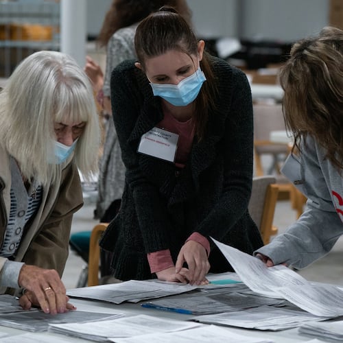 Election personnel sort absentee ballot applications at the Gwinnett County Board of Voter Registrations and Elections offices on Nov. 7, 2020, in Lawrenceville. (Elijah Nouvelage/Getty Images/TNS)