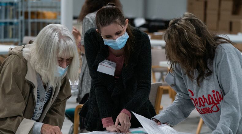 Election personnel sort absentee ballot applications at the Gwinnett County Board of Voter Registrations and Elections offices on Nov. 7, 2020, in Lawrenceville. (Elijah Nouvelage/Getty Images/TNS)