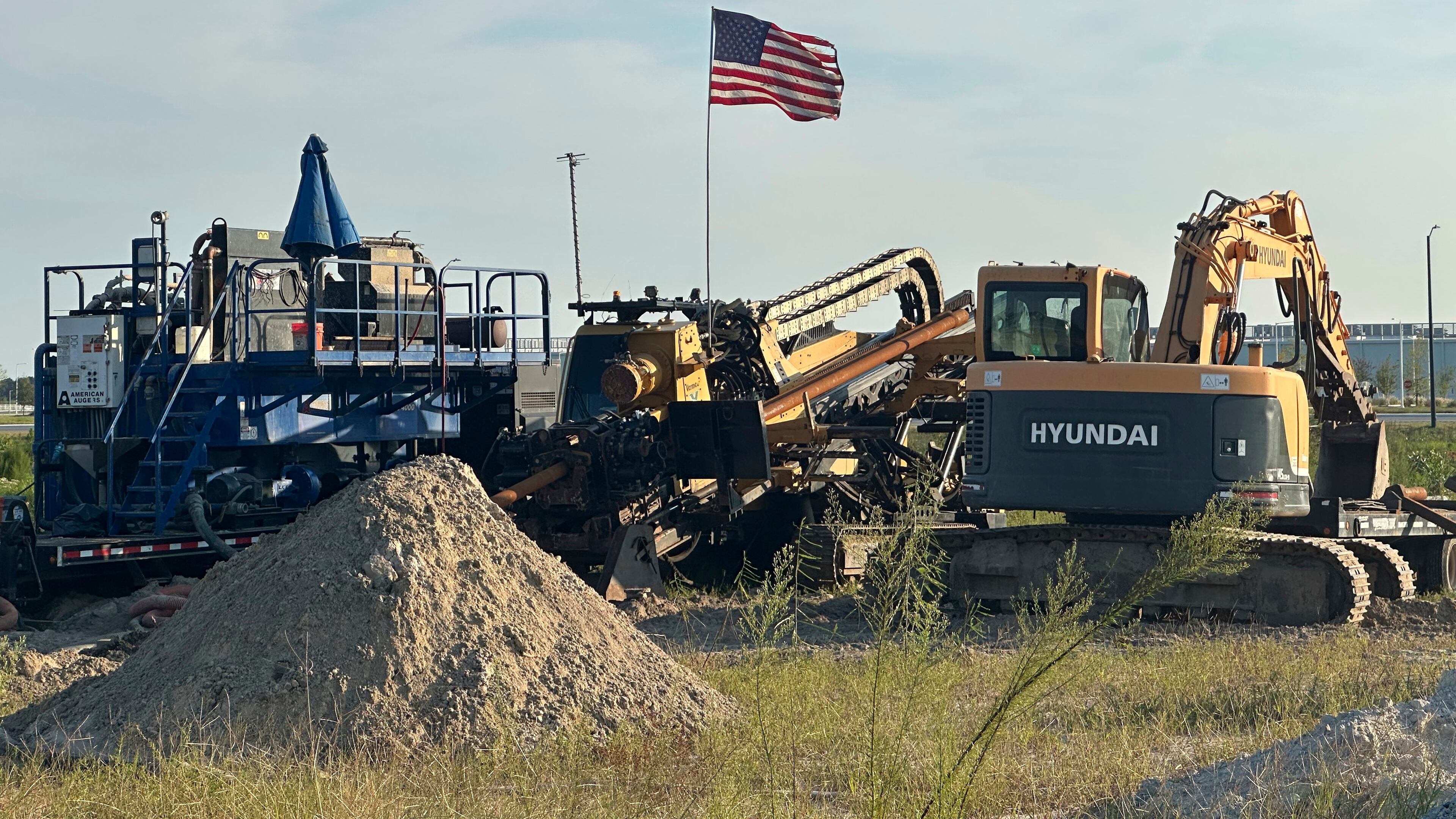 An American flag flies above a piece of heavy machinery at the site of Hyundai Motor Group's electric vehicle plant in Ellabell, Georgia, Friday, Sept. 5, 2025. (AP Photo/Russ Bynum)