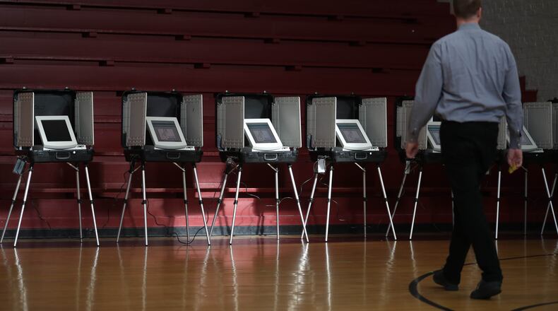 July 24, 2018 - Atlanta, Ga: A voter walks toward the voting booths during the Georgia runoff election voting at Henry W. Grady High School Tuesday, July 24, 2018, in Atlanta. (JASON GETZ/SPECIAL TO THE AJC)