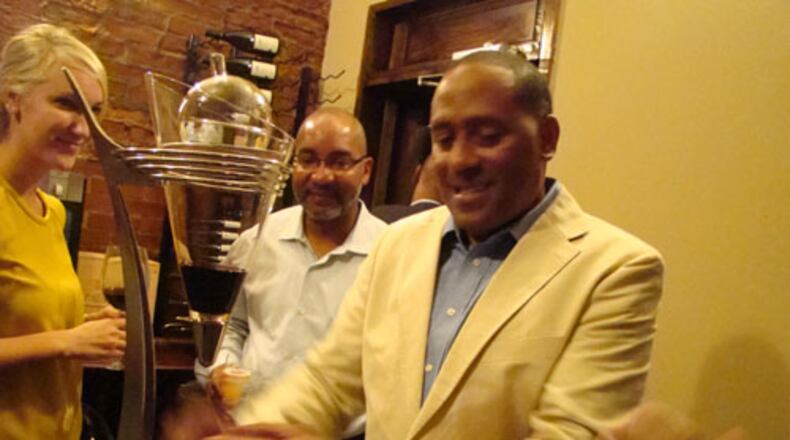 Frank Ski pouring wine at his opening party at Frank Ski's in September, 2011. CREDIT: Rodney Ho/rho@ajc.com