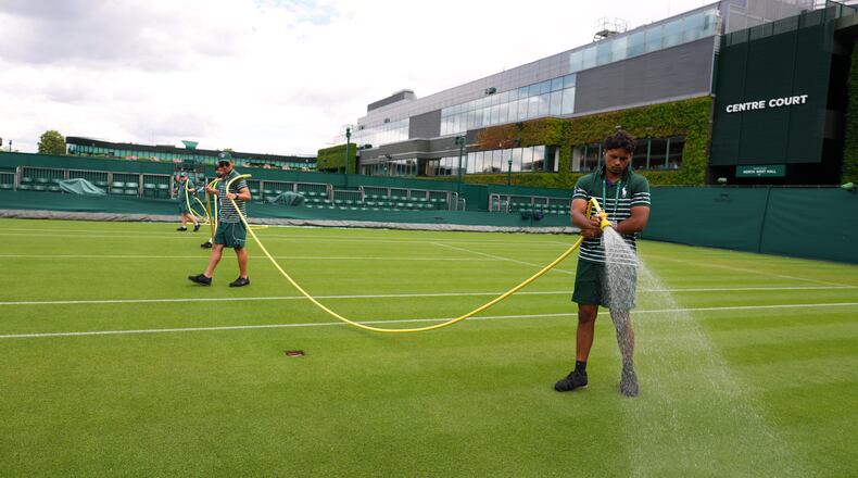 Ground staff waters a court one day ahead of the start of the Wimbledon Tennis Championships in London, Sunday, June 28, 2026.(AP Photo/Kirsty Wigglesworth)