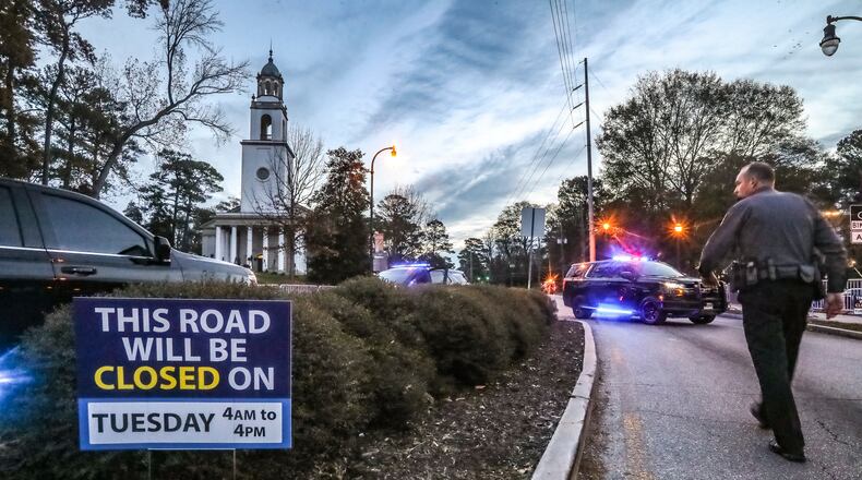 Law enforcement block part of Decatur Road near Emory University where heavier than usual traffic in Atlanta was prevalent on Tuesday, Nov. 28, 2023 as presidents and first ladies, past and present, along with other high-profile politicians traveled into the city to pay their respects to former first lady Rosalynn Carter.  (John Spink / John.Spink@ajc.com)