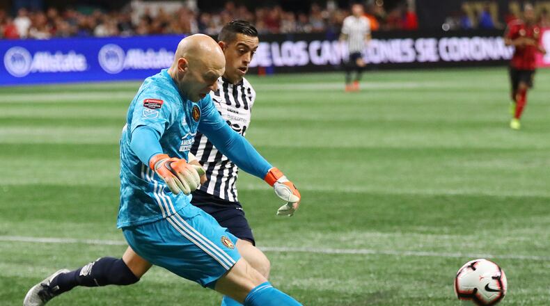 March 13, 2019 Atlanta: Atlanta United goalkeeper Brad Guzan clears the ball away from Monterrey forward Rogelio Funes Mori in a Concacaf Champions league quarterfinal match on Wednesday, March 13, 2019, in Atlanta.    Curtis Compton/ccompton@ajc.com