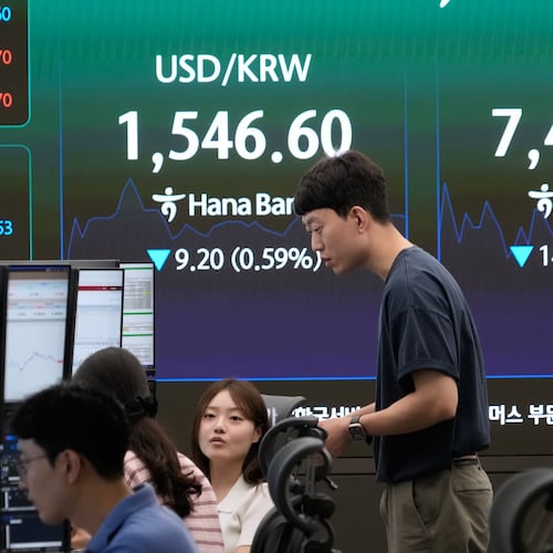 Currency traders work near a screen showing the Korea Composite Stock Price Index (KOSPI) and the foreign exchange rate between U.S. dollar and South Korean won at the foreign exchange dealing room of the Hana Bank headquarters in Seoul, South Korea, Friday, July 3, 2026. (AP Photo/Ahn Young-joon)