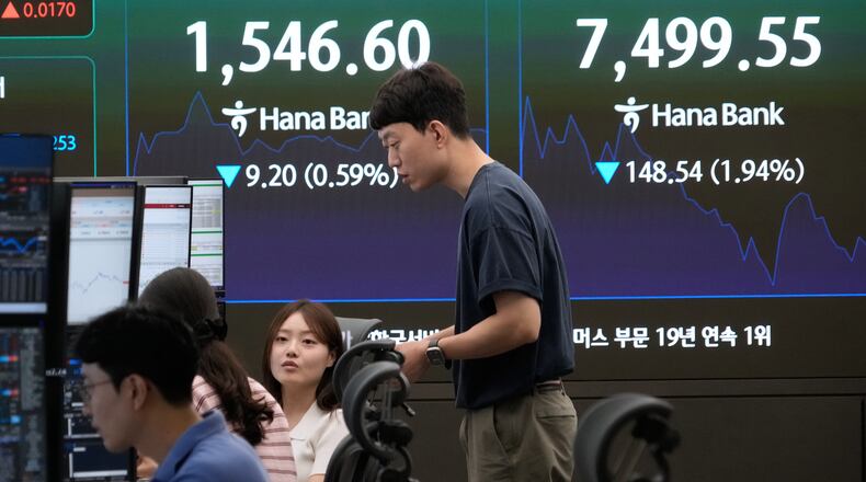 Currency traders work near a screen showing the Korea Composite Stock Price Index (KOSPI) and the foreign exchange rate between U.S. dollar and South Korean won at the foreign exchange dealing room of the Hana Bank headquarters in Seoul, South Korea, Friday, July 3, 2026. (AP Photo/Ahn Young-joon)