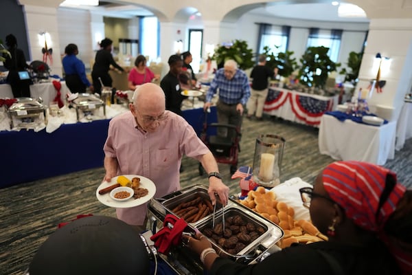 Dining room staff serve up an Independence Day buffet to residents, in the independent living community at the Toby and Leon Cooperman Sinai Residences, July 4, 2025, in Boca Raton, Fla. (AP Photo/Rebecca Blackwell)