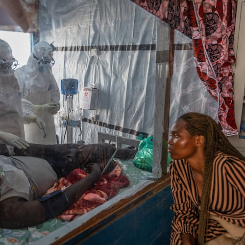 Health workers tend to an Ebola patient at the Rwampara Treatment Center in Ituri, Congo, Thursday, June 18, 2026. (AP Photo/Moses Sawasawa)