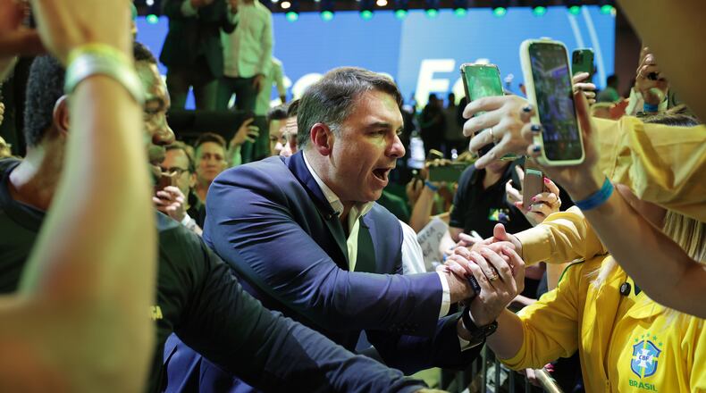 Brazilian Sen. Flavio Bolsonaro greets supporters as he arrives to the Liberal Party convention where he was confirmed as the party's presidential candidate, in Sao Paulo, Saturday, July 25, 2026. (AP Photo/Ettore Chiereguini)