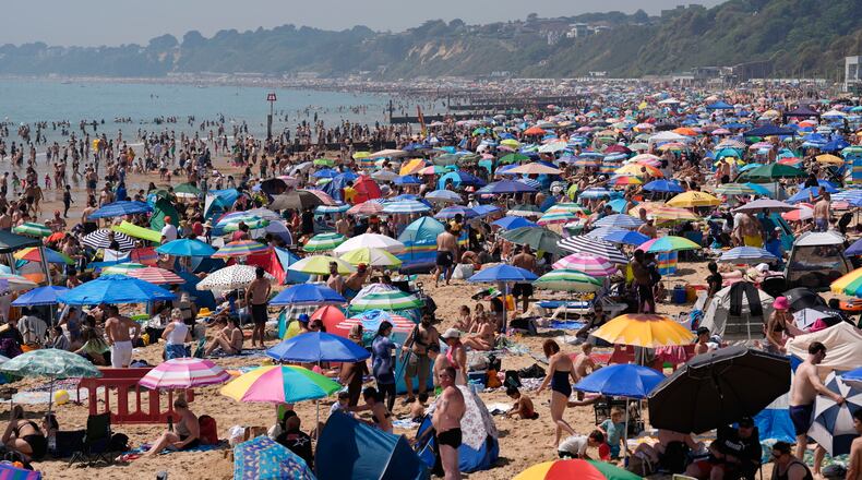 People visit Bournemouth beach, south England, Monday May 25, 2026. (Andrew Matthews/PA via AP)
