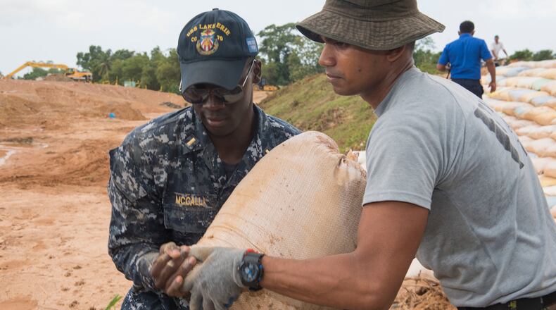 Morehouse graduate Lt. j.g. Asante McCalla (left) worked to repair levees in Matara, Sri Lanka, June 12, 2017, during humanitarian assistance operations.