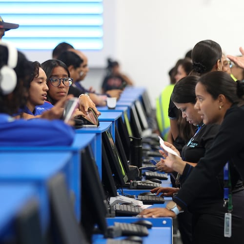 Passengers check in at Simon Bolivar International Airport as it reopens to commercial flights two months after closing due to the earthquake in Maiquetia, Venezuela, Tuesday, Sept. 1, 2026. (AP Photo/Pedro Mattey)